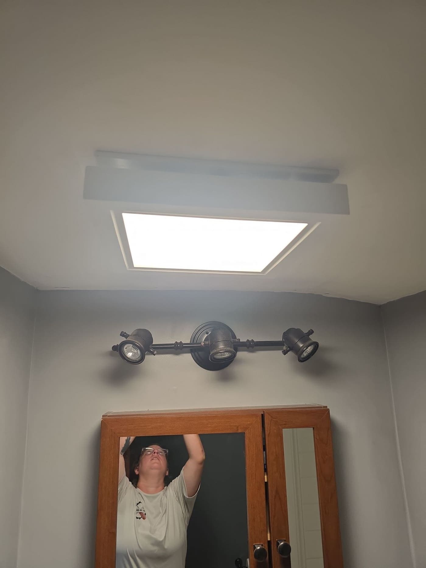 Electrician installing a light fixture